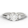 A three-stone diamond ring with a round center diamond and two marquise-cut side diamonds on a polished silver-colored band, set against a plain white background.