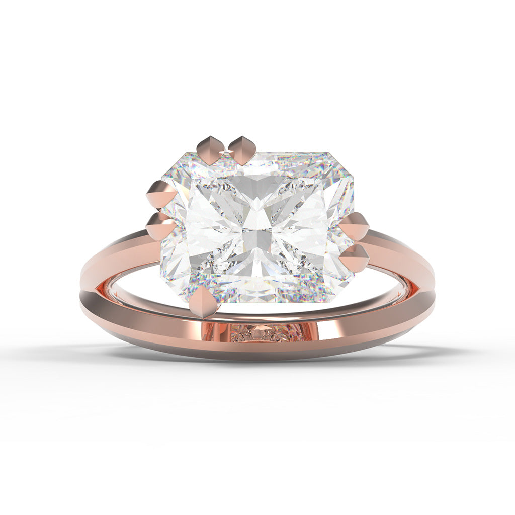 Rose gold ring with a large radiant cut diamond with split band and leaf shaped claw setting
