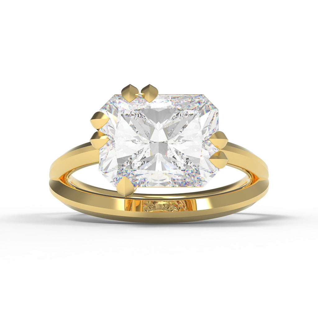 Yellow gold ring with a large radiant cut diamond, East-West set in a split band with leaf shaped claw settings.