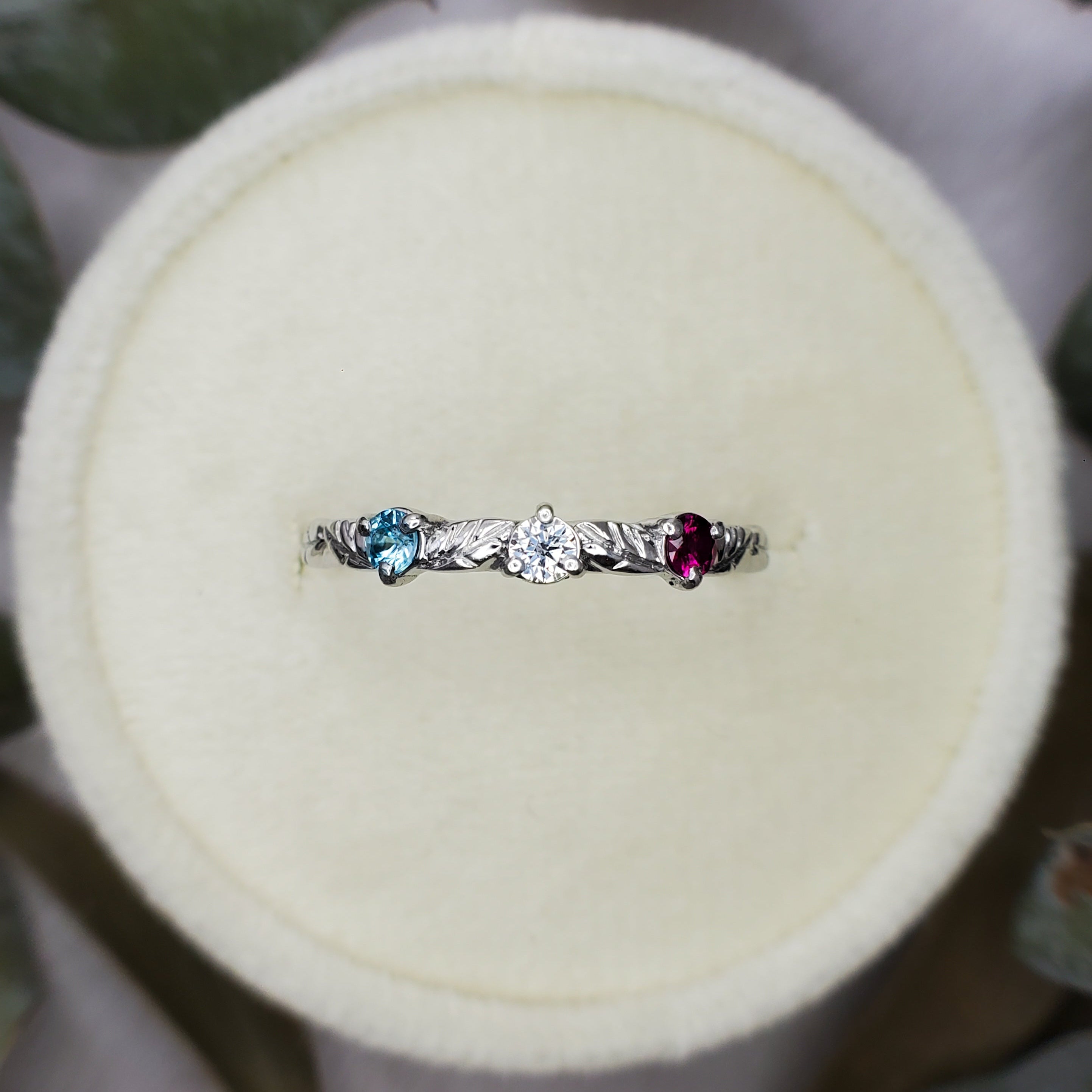 Platinum ring with engraved leaves and gemstones, by Chayle Jewellery Studio.