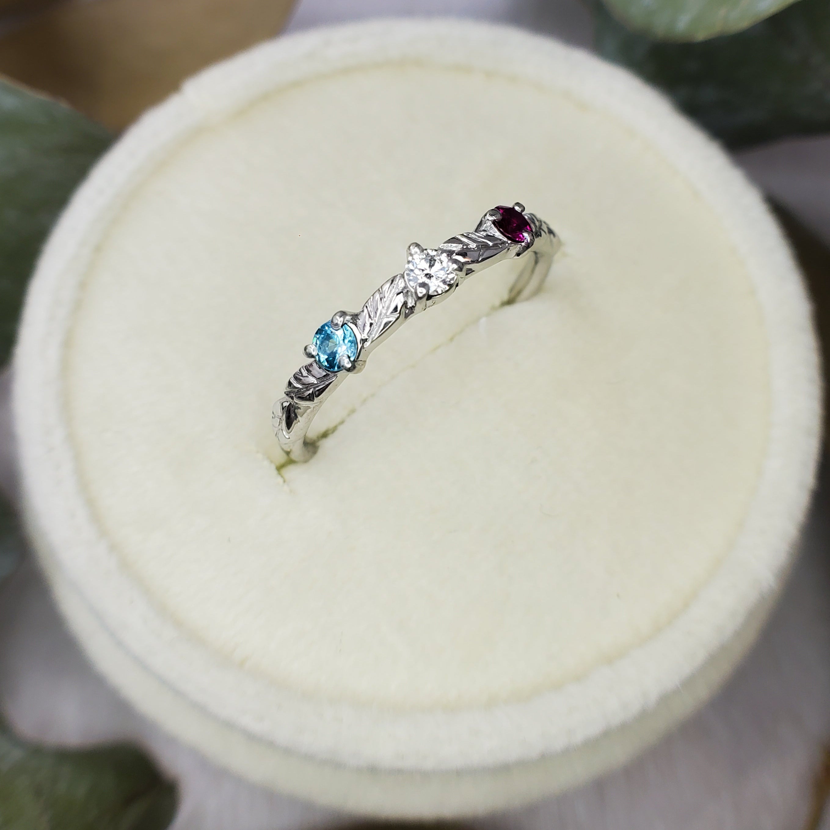 Platinum ring with engraved leaves and gemstones, by Chayle Jewellery Studio.