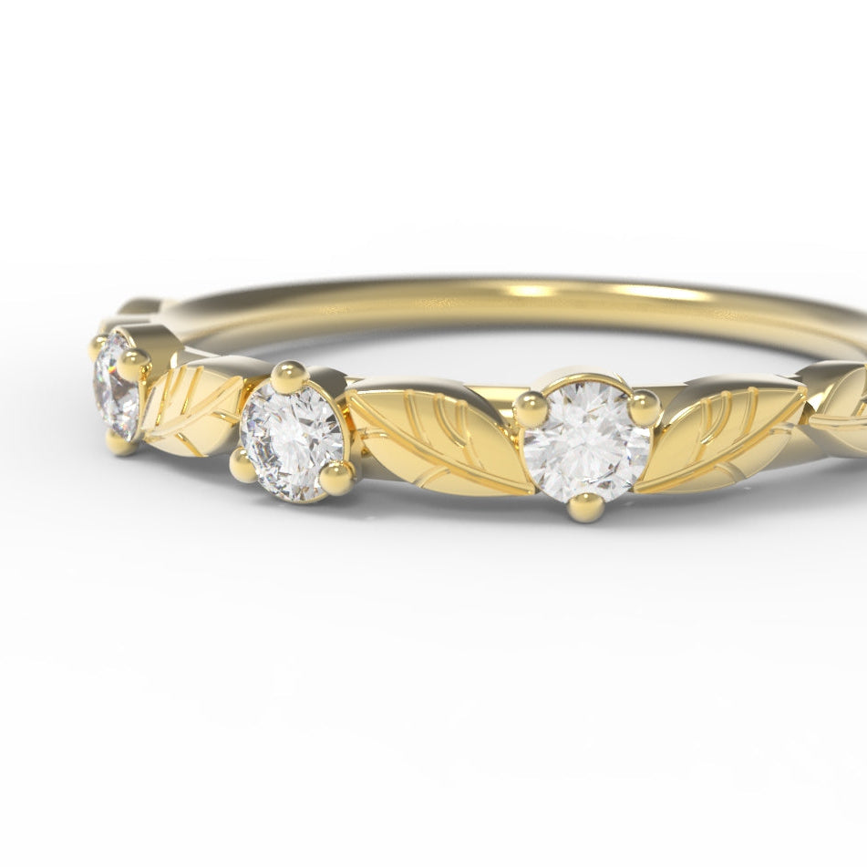 Engraved Gold ring with diamond stones on a white background