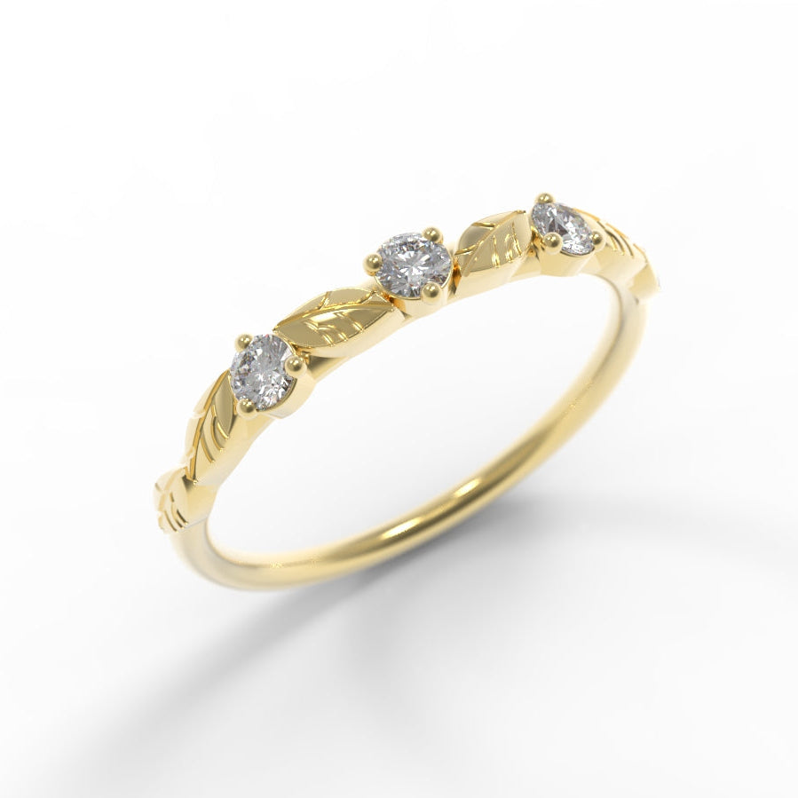 Hand engraved Leaves on Gold ring with three diamonds on a white background.