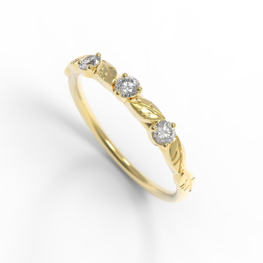Hand engraved leaves on a gold ring with three diamonds on a white background by Chayle Jewellery Studio.