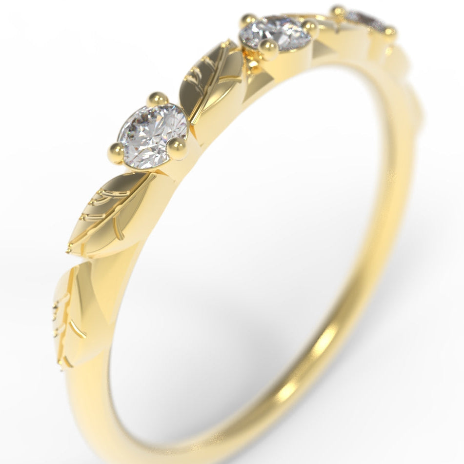 Hand engraved Gold leaf ring with three diamonds on a white background.
