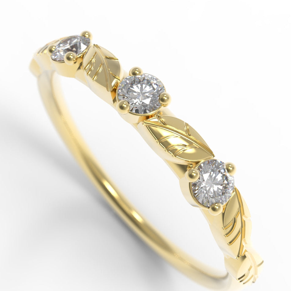 Hand engraved Gold leaf ring with three diamonds on a white background.