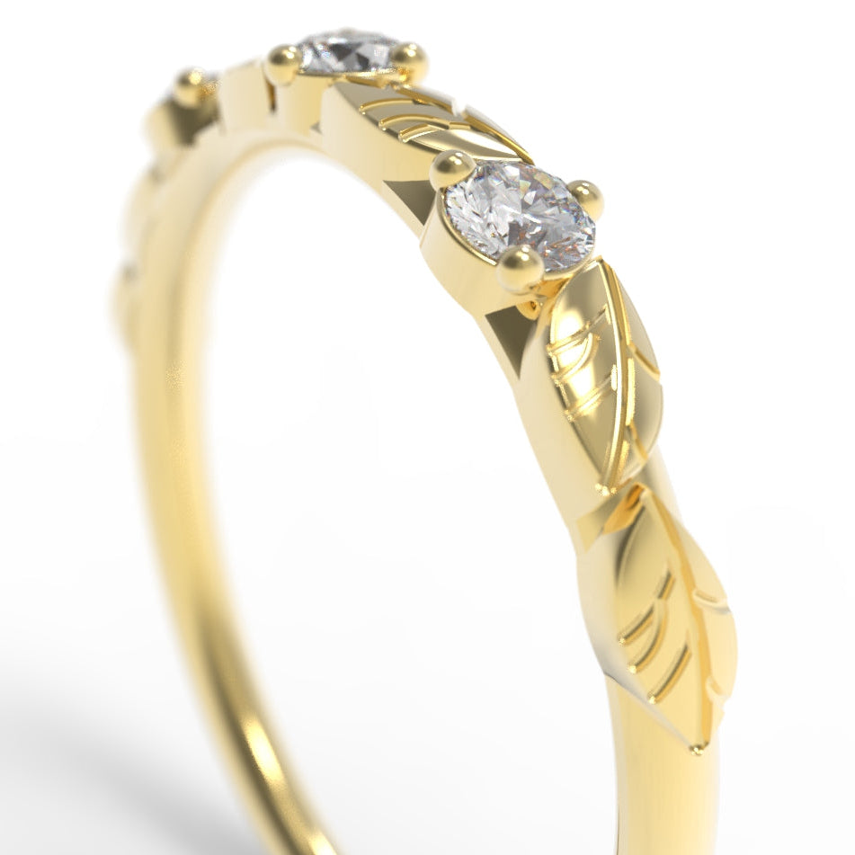Hand engraved Gold leaf ring with three diamonds on a white background.