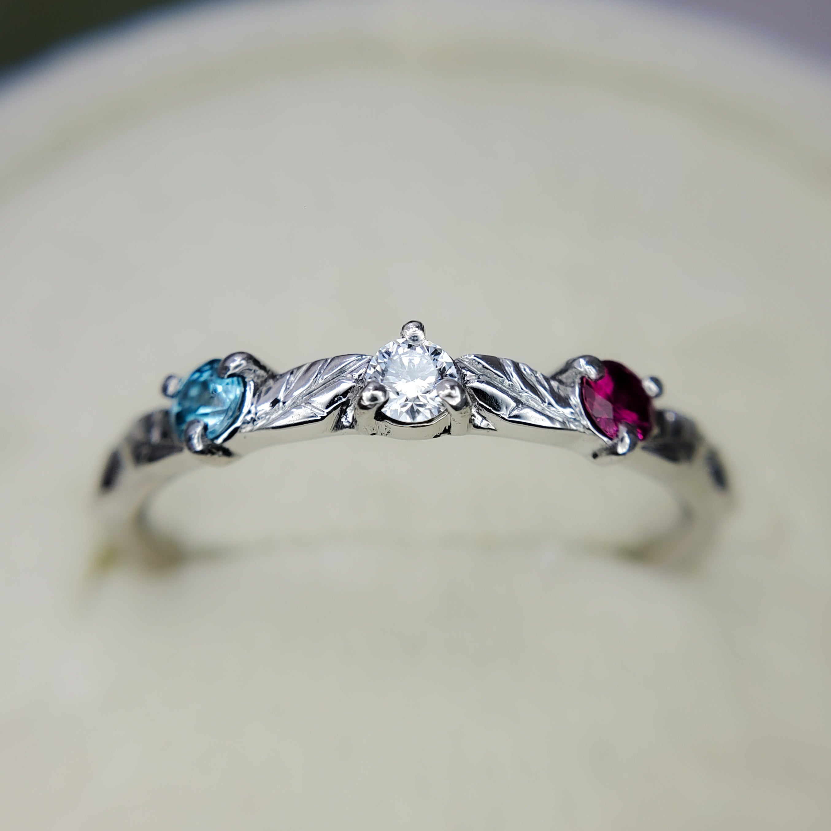 Platinum ring with engraved leaves and gemstones, by Chayle Jewellery Studio.