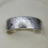 Textured wedding band on white background. Ethically handmade by Chayle Jewellery in Ottawa, Canada.